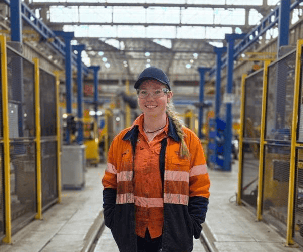 Female apprentice in industrial setting at Downer Group Australia.