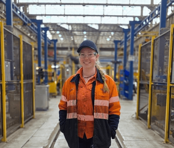Female apprentice in industrial setting at Downer Group Australia.